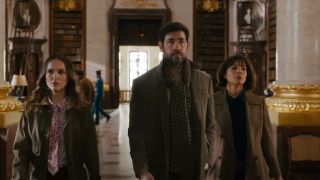 John Krasinski, Natalie Portman and Carmen Ejogo walking through a library in Fountain of Youth