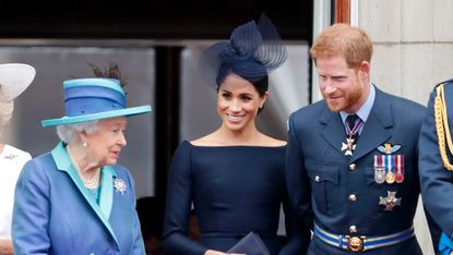 Queen and Meghan, Duchess of Sussex and Prince Harry, Duke of Sussex watch a flypast to mark the centenary of the Royal Air Force from the balcony of Buckingham Palace on July 10, 2018 in London, England.