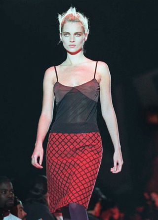 Kate Moss walking on the catwalk in the 90s