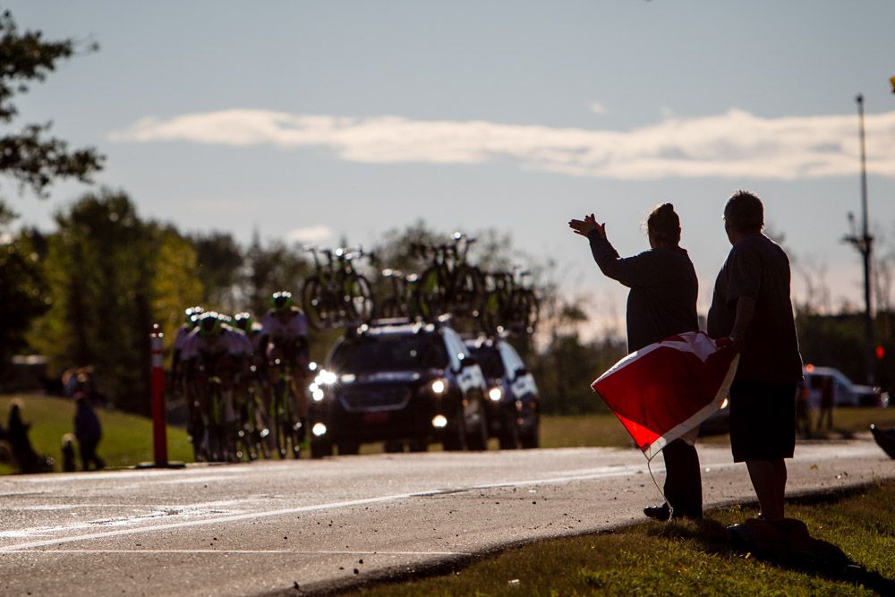 Fans cheer as a team heads out on course