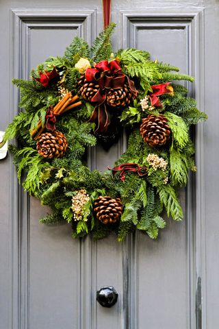 Christmas Wreath hanging on a gray painted gray door