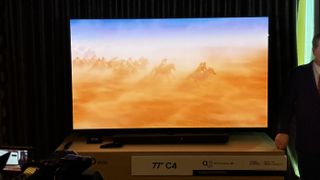 The LG C4 TV in a hotel room, demoing a movie