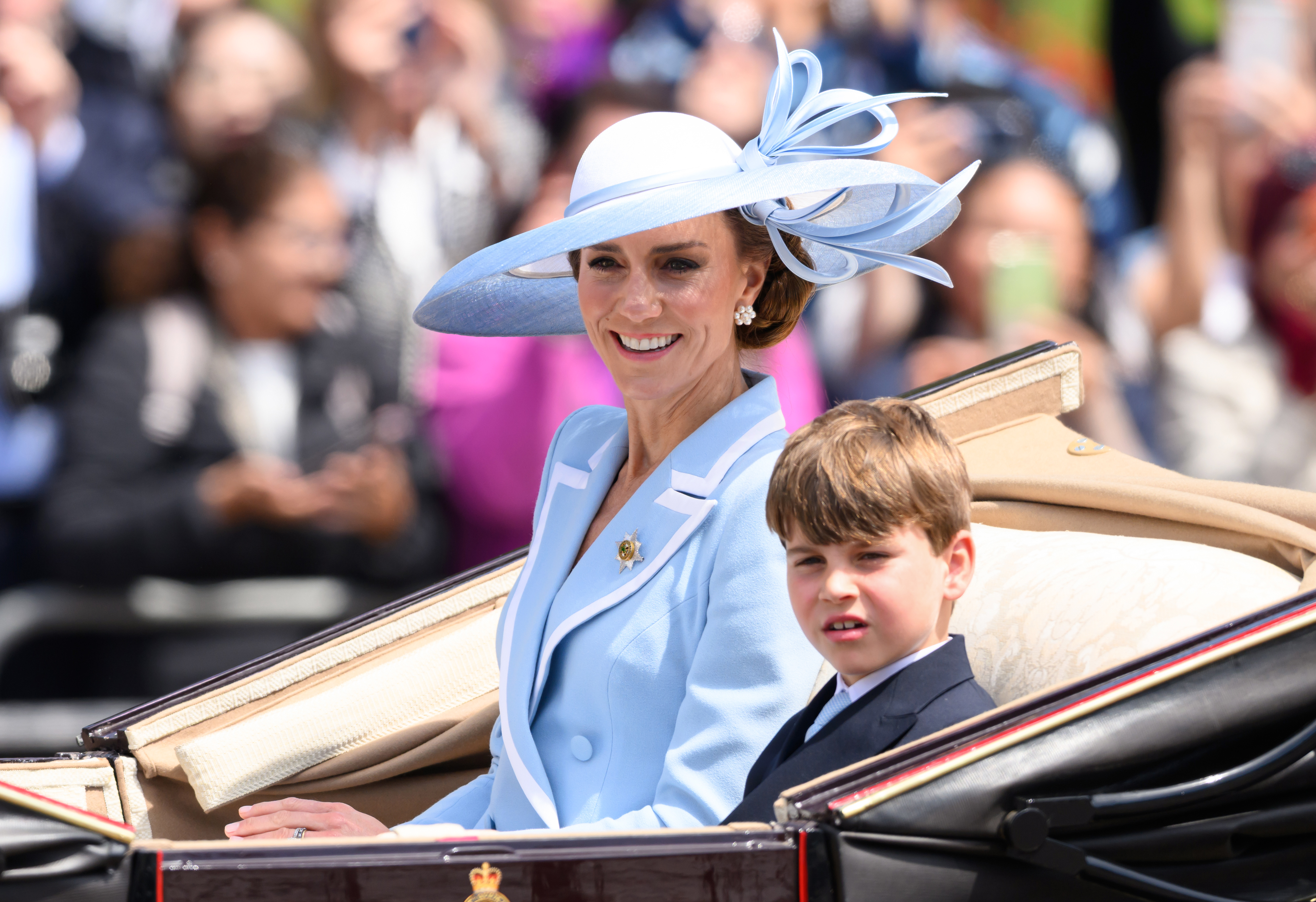 Princess Kate riding in a carriage with Prince Louis