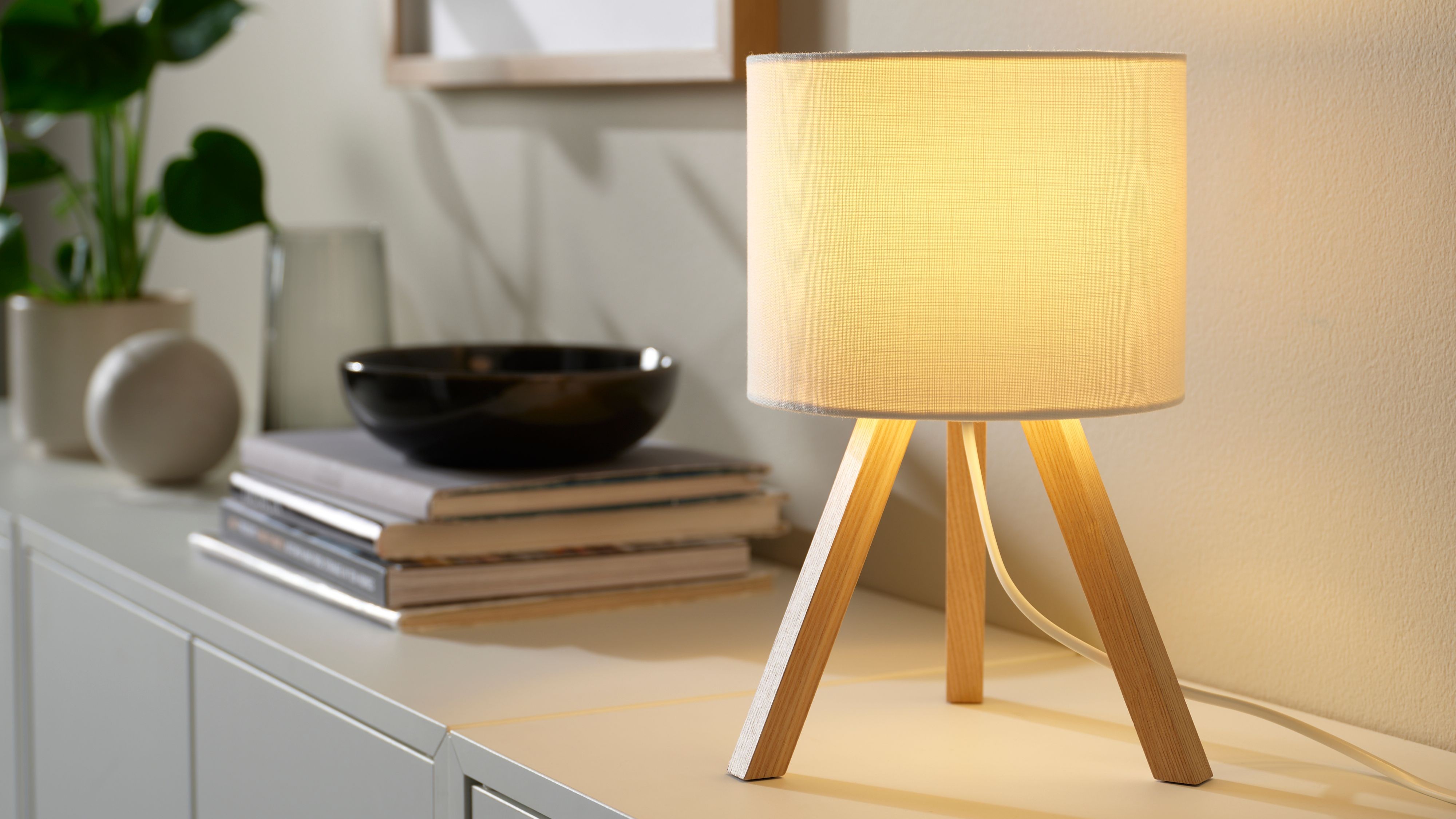 The new Kajplats smart bulb inside a lamp on top of a unit