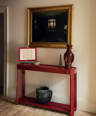 Lacquer red console/ side table with antique vase and ornaments and old painting