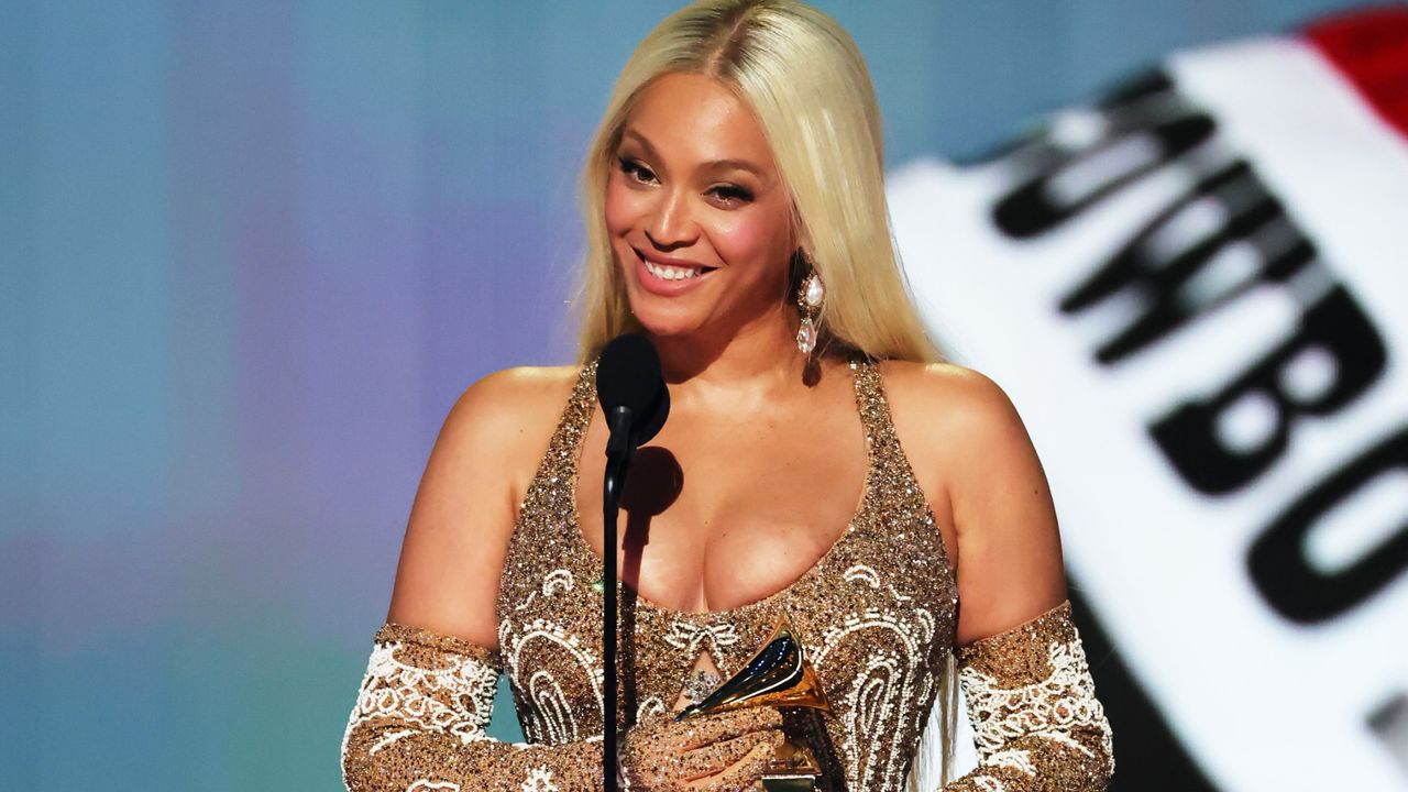 beyonce as she wins album of the year with cowboy carter banner behind her at the 2025 grammys