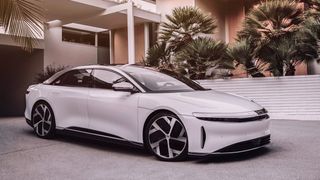 The Lucid Air parked outside a modern house