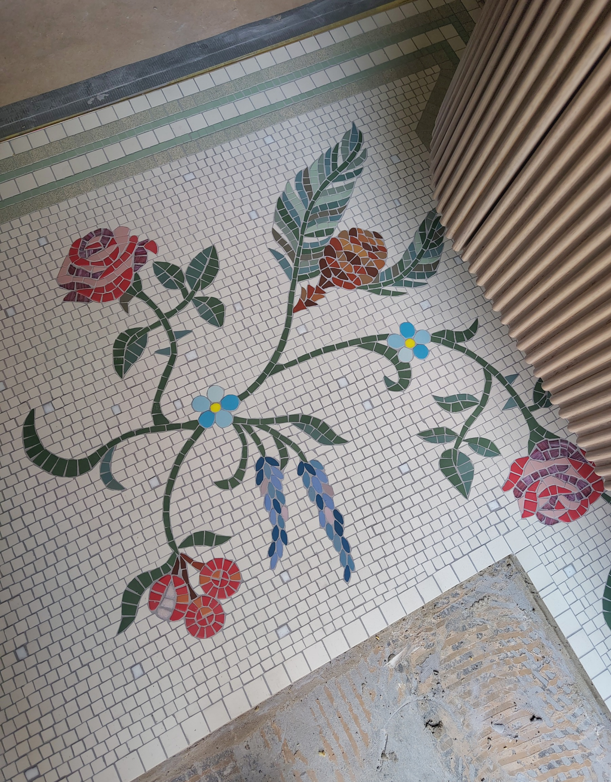 a floral motif mosaic on the bathroom floor