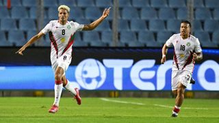 Suriname's midfielder #08 Justin Lonwijk (L) celebrates next to teammate midfielder #18 Jayden Turfkruier (R) after scoring his team's first goal during the 2026 FIFA World Cup Concacaf qualifier football match between El Salvador and Suriname at the Cuscatlan stadium in San Salvador on June 10, 2025.