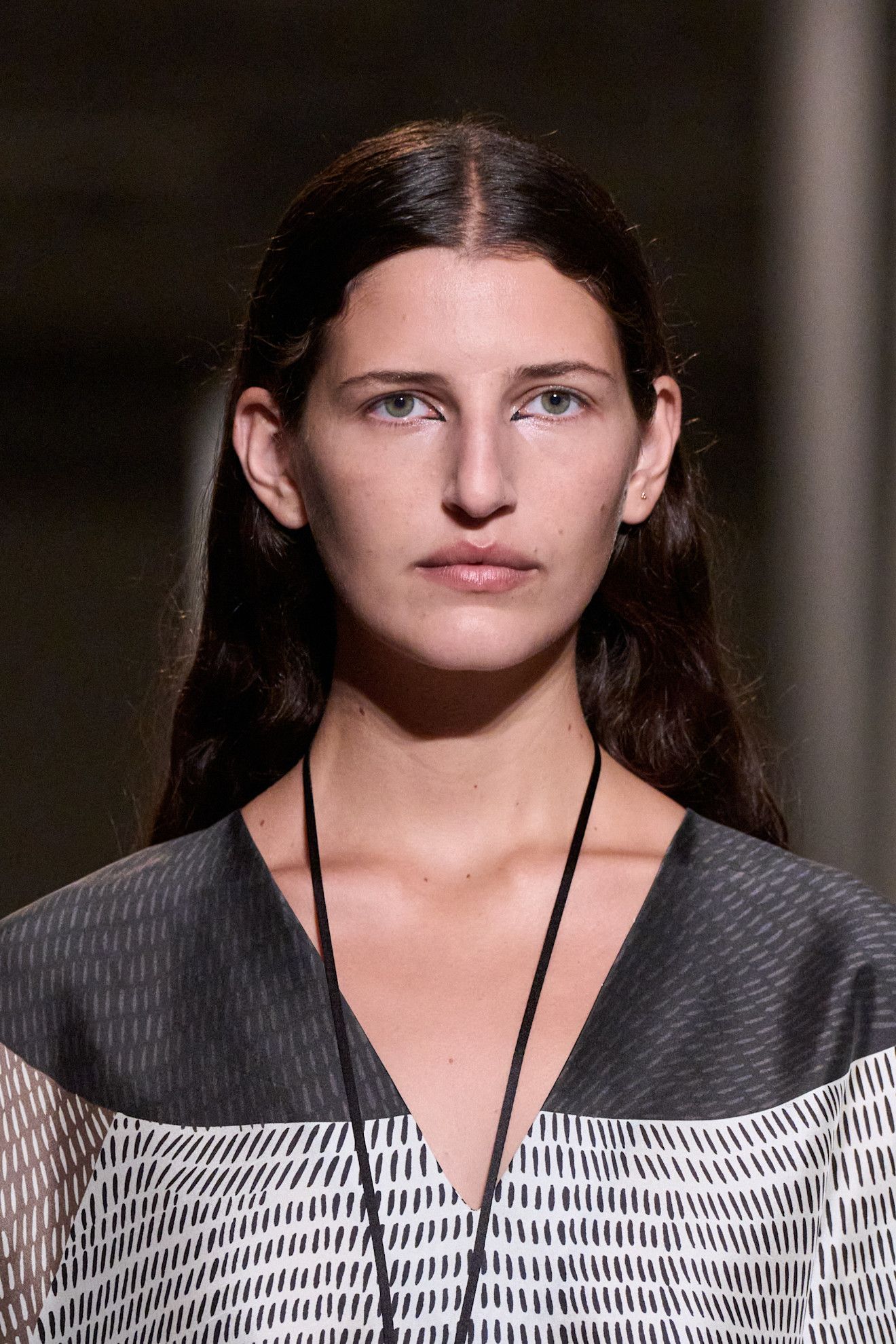 Inner corner liner at Heirelome on a girl with brown hair in a v neck.