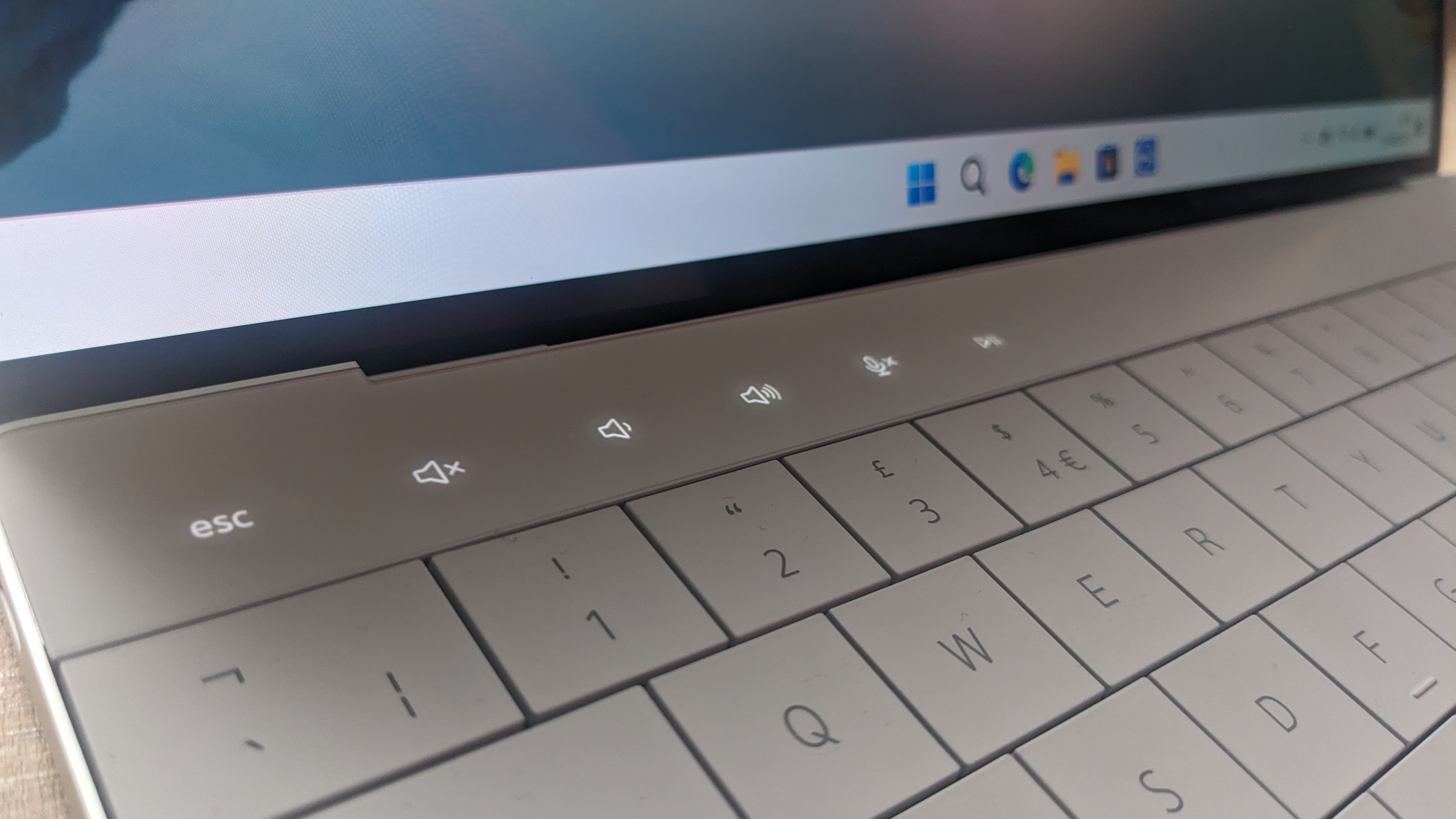 The Dell XPS 13 Plus photographed on a wooden desk.