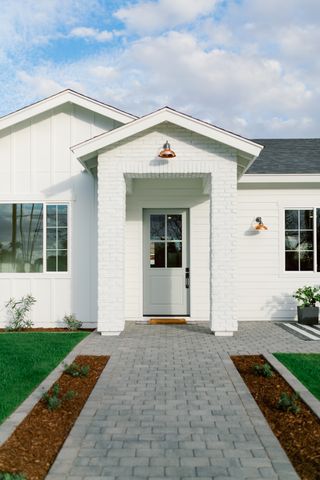 White house exterior with paved entryway