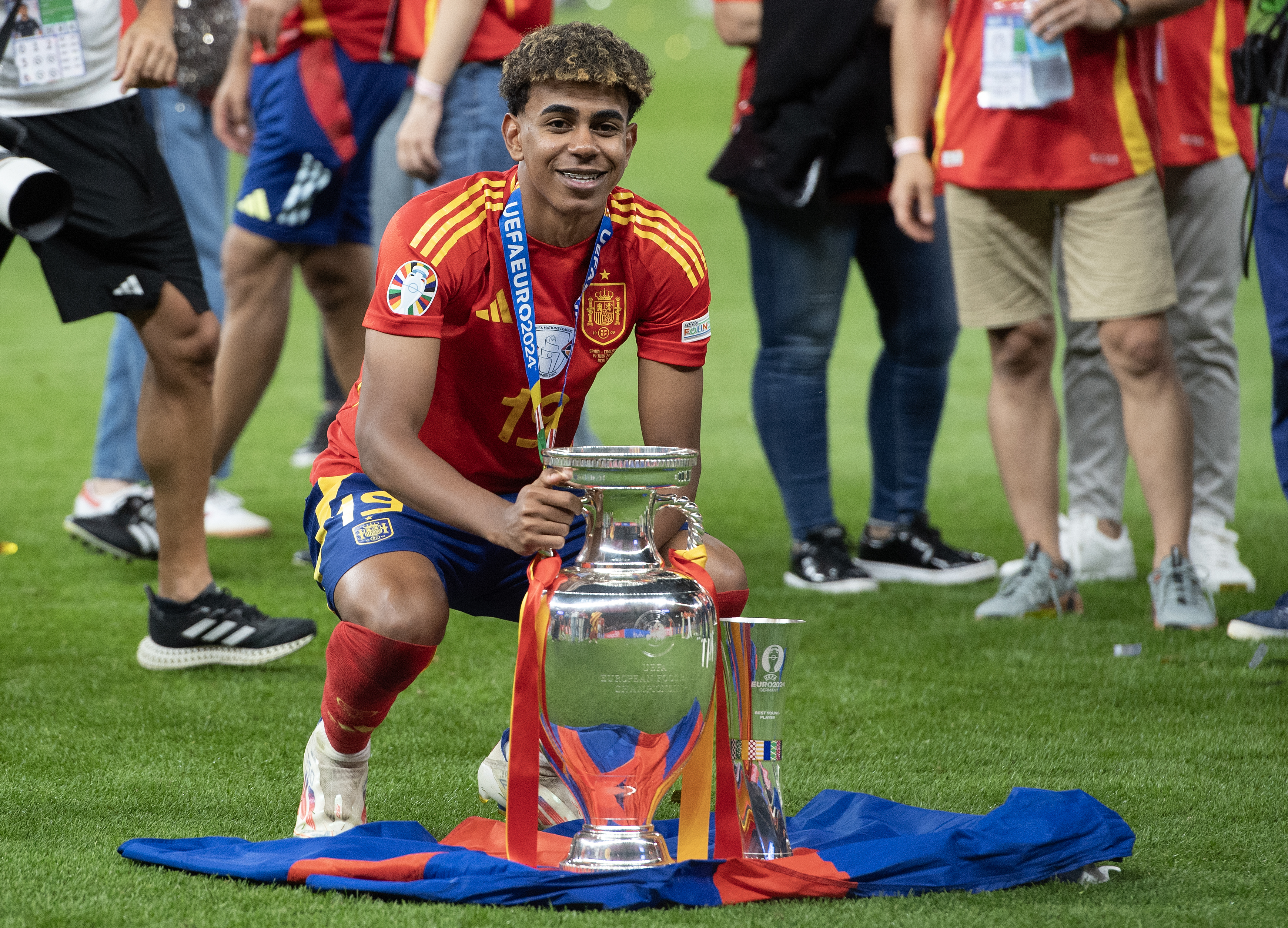 Lamine Yamal poses with the European Championship trophy after Spain's Euro 2024 final win against England in July 2024.