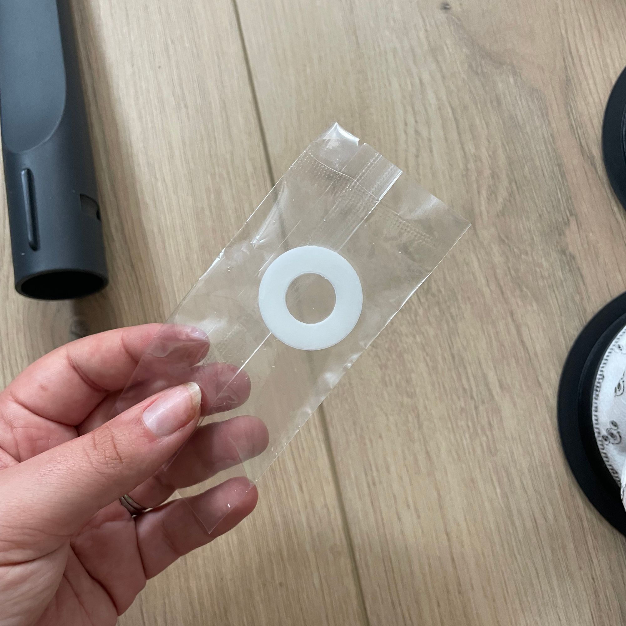 hand holding a round scent pod of the Henry Quick Corded  Vacuum Cleaner