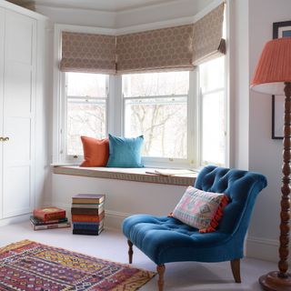 bay living room window with blue accent chair
