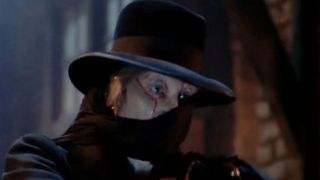 Robert Englund in a mask and hat under shadows in The Phantom of the Opera