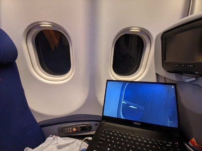 Rami Ismail playing Microsoft Flight Simulator on a flight.