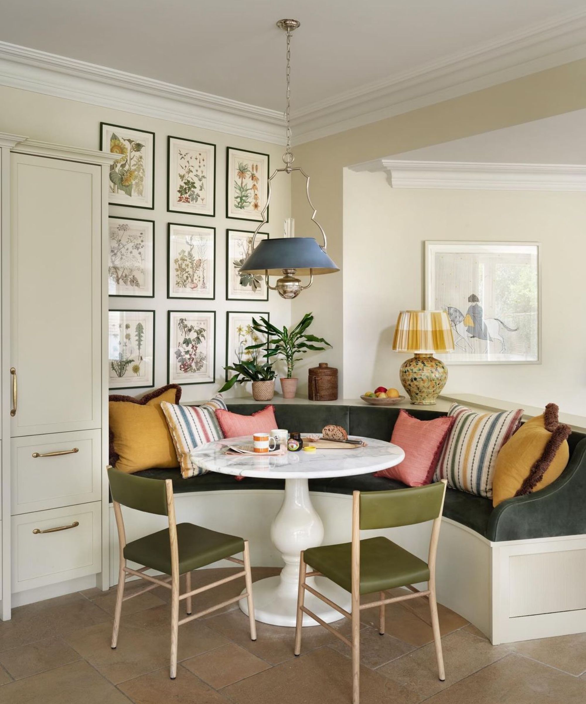 An open plan kitchen with a curved banquette to create a divide between spaces