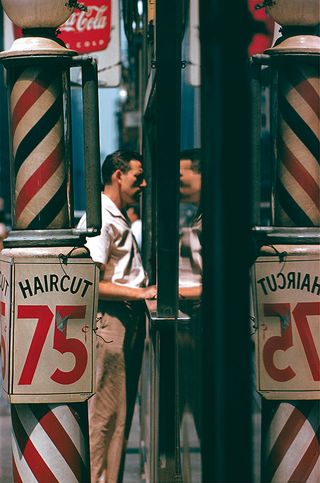 Saul Leiter portrait of a man outside a New York barbershop