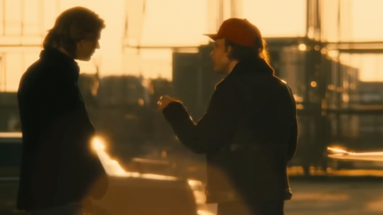 Chris Hemsworth and Daniel Bruhl from behind, speaking to each other at the end of Rush