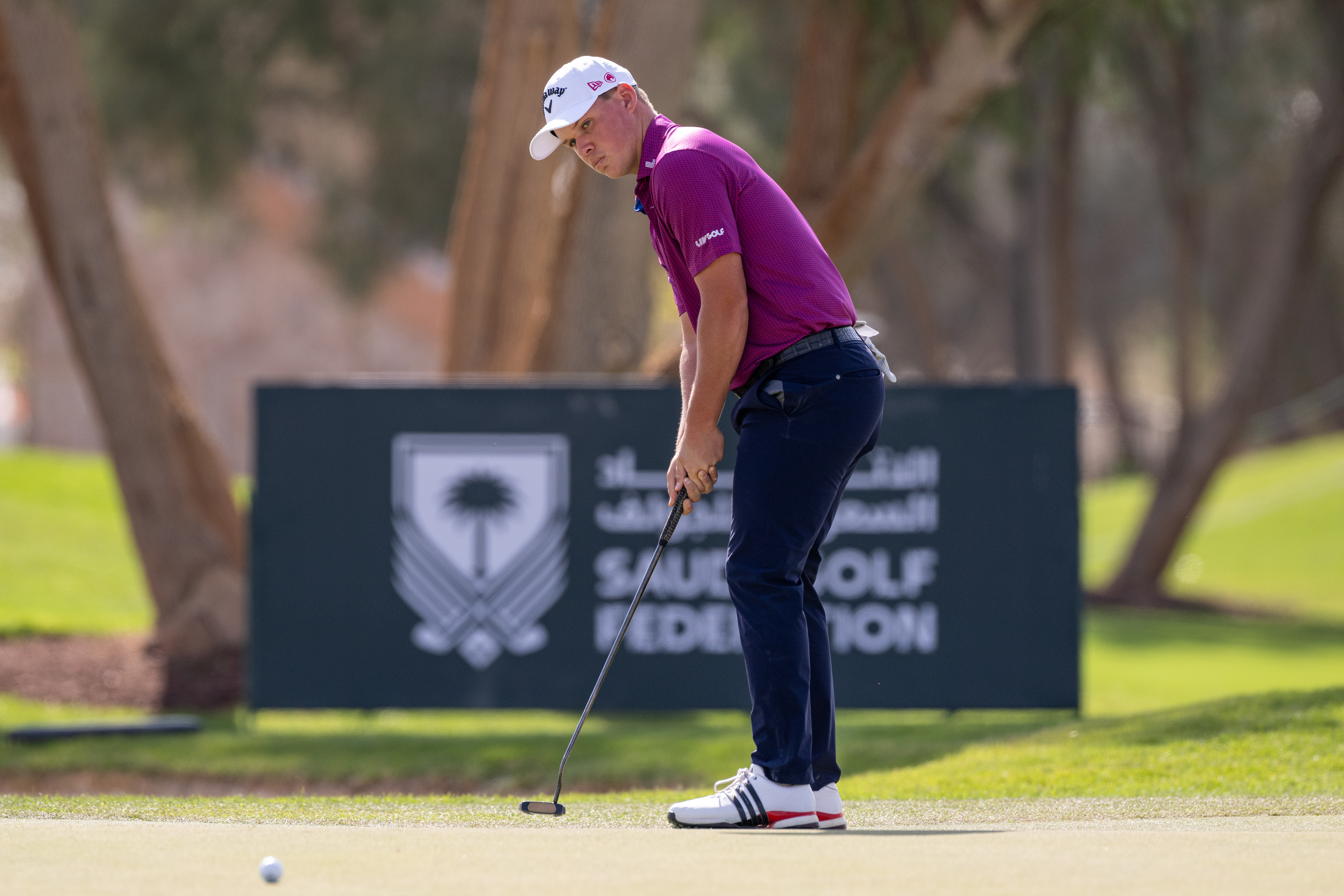 Caleb Surratt hits a putt on the green