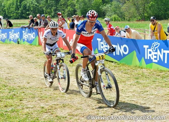 Julien Absalon (Bmc Mountainbike Racing Team) &amp; Nino Schurter (Scott Swisspower MTB Racing Team) through the feedzone for the last time