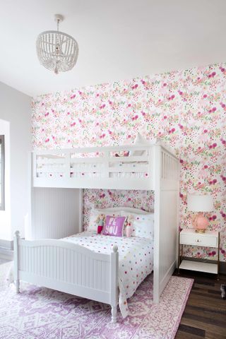 Girls bedroom with bunk bed and pink wallpaper