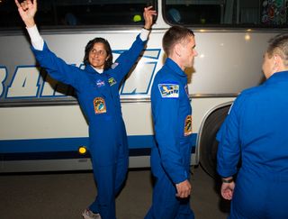 Expedition 32 flight engineer Sunita Williams of NASA waves goodbye before launching to space station.