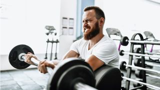 A man performing barbell bicep curl