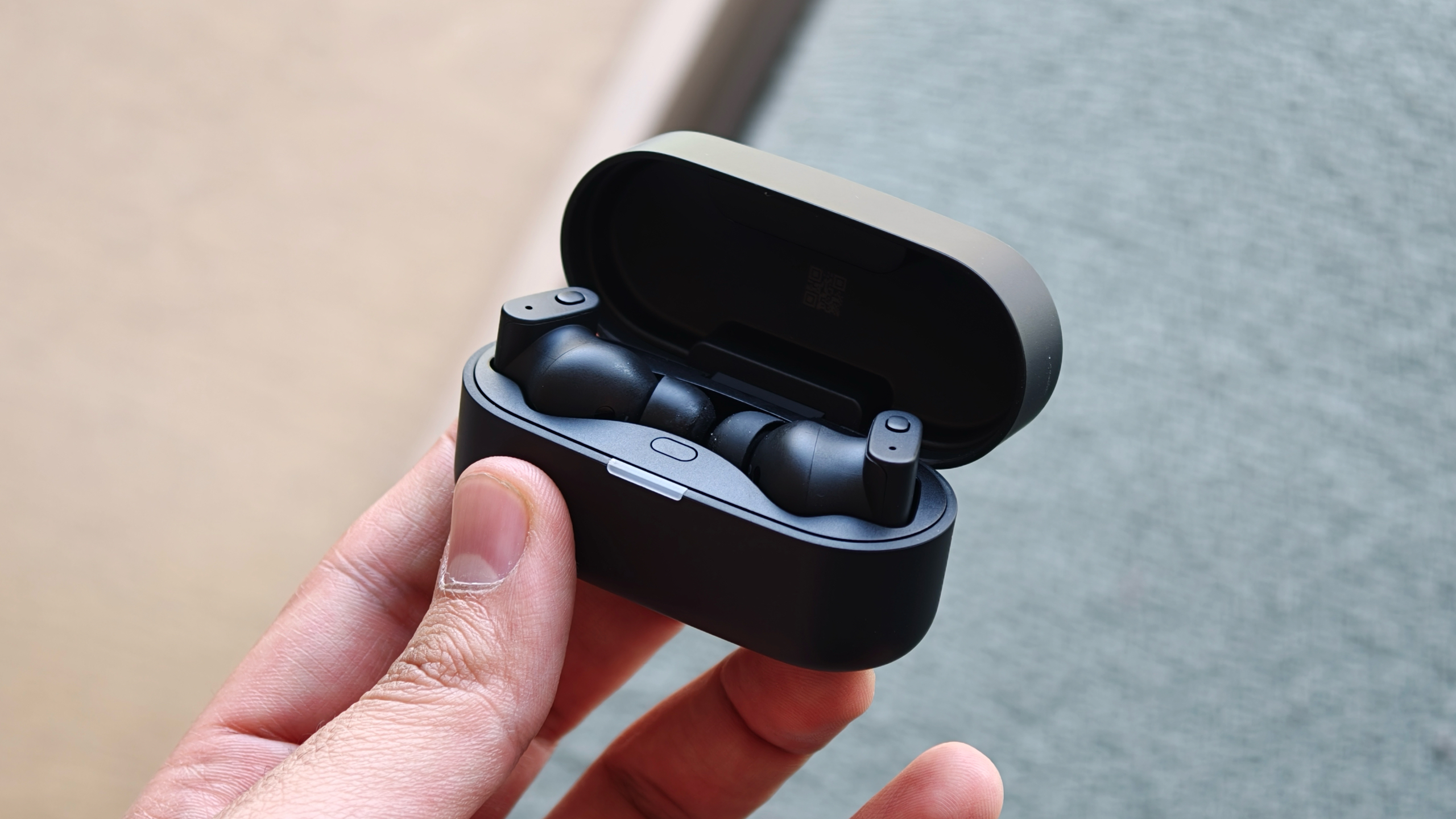 Status Audio Pro X earbuds in hand