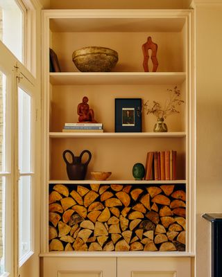 Decorated in built shelving in a period property in Wimbledon using antique statues and books