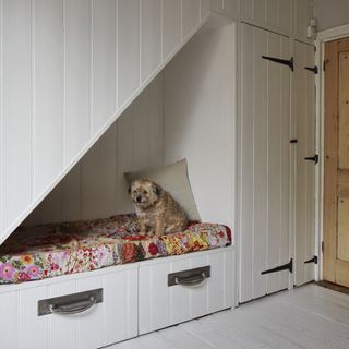 understairs cubbyhole with white wall