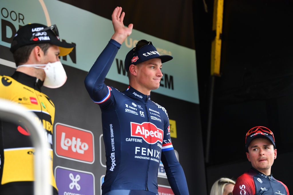 WAREGEM BELGIUM MARCH 30 Mathieu Van Der Poel of Netherlands and Team AlpecinFenix celebrates at podium as race winner during the 76th Dwars Door Vlaanderen 2022 Mens Elite a 1837km one day race from Roeselare to Waregem DDV22 DDVmen WorldTour on March 30 2022 in Waregem Belgium Photo by Luc ClaessenGetty Images