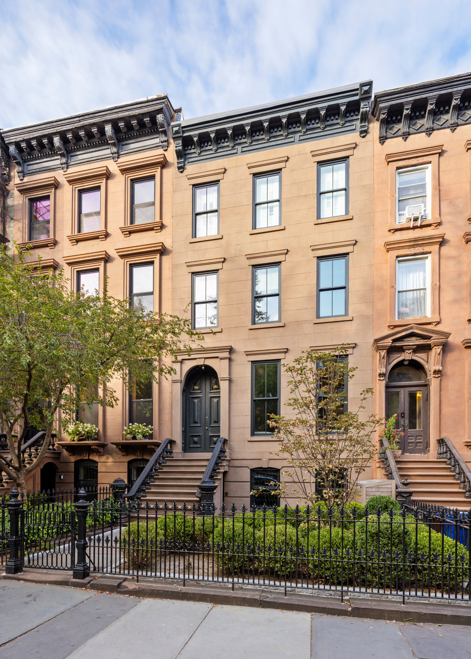 Brooklyn brownstone facade with green planted front garden
