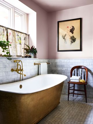 period style brass freestanding bath with vintage chair and white metro tiles cafe curtains and artwork