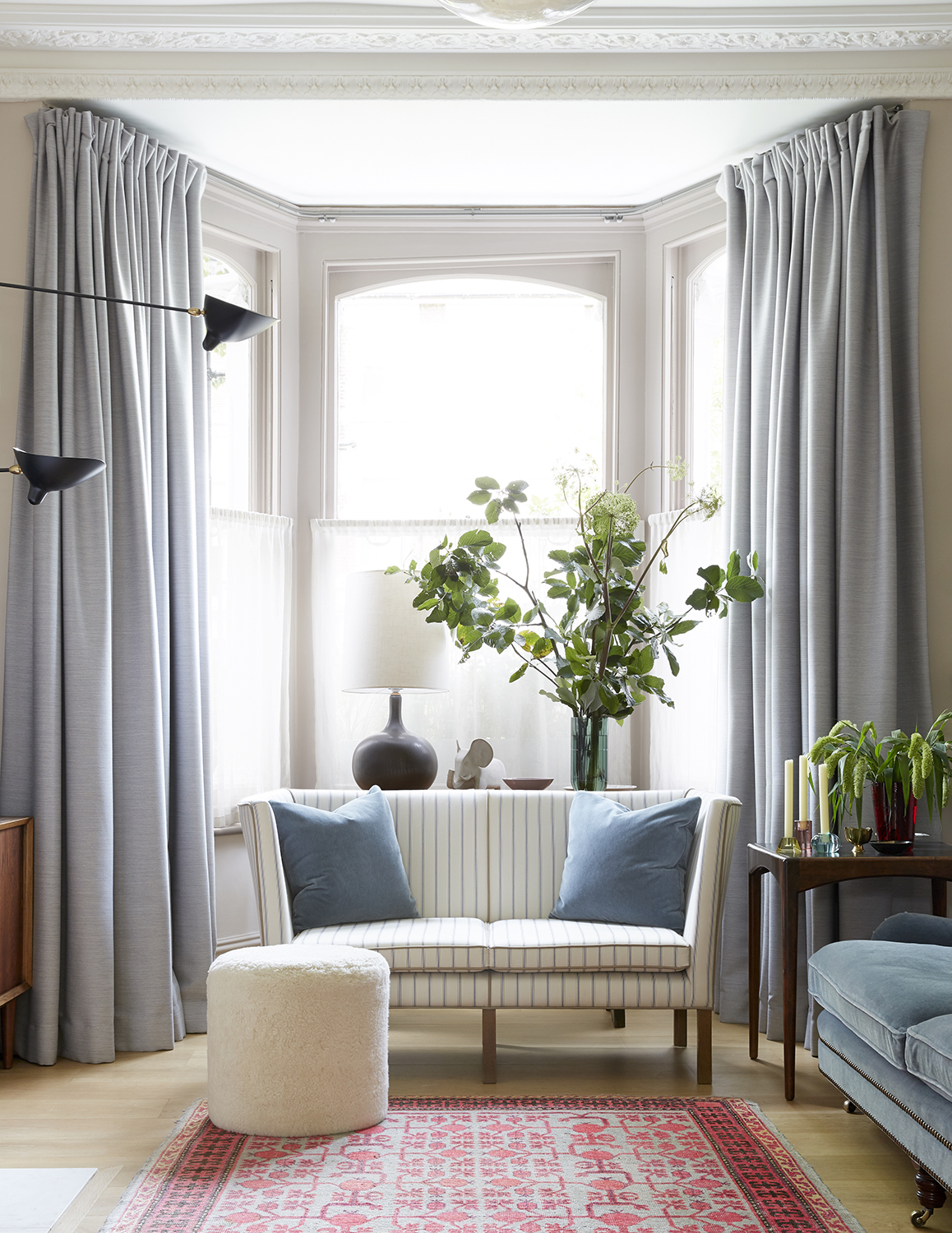 neutral living room with white sofa and gray curtains