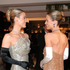 Amelia and Eliza Spencer in gold and silver gowns at the Vienna Opera Ball