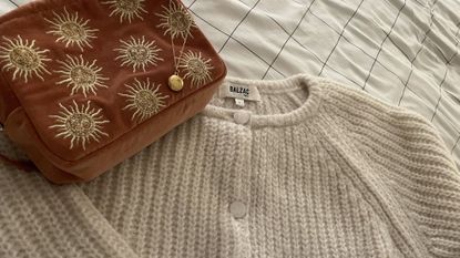 tried and tested gifts: gold necklace, makeup bag, and knitted jumper from the gift guide