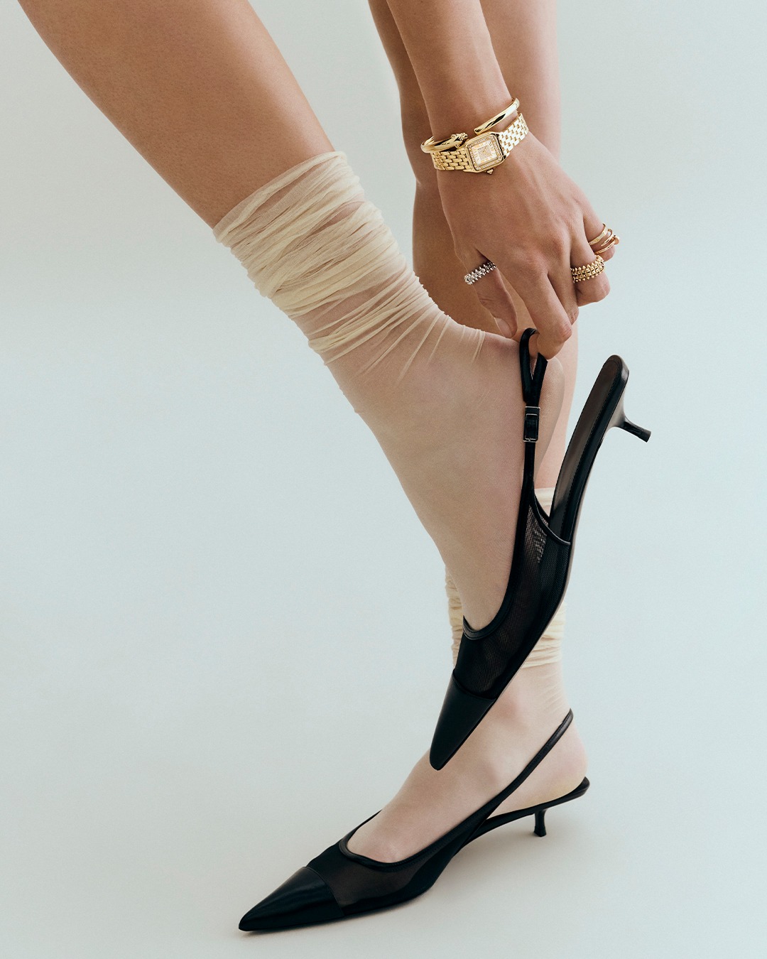 Woman wearing Cartier jewelry.
