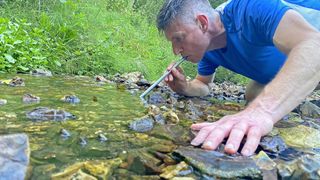 Man using LifeStraw Sip in stream