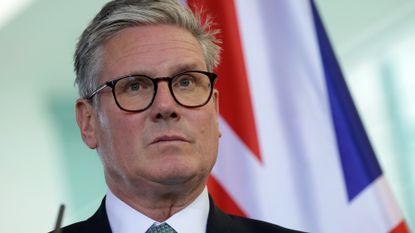 Keir Starmer standing in front of the Union Flag