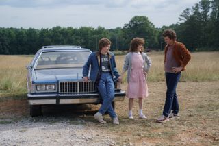 charlie heaton natalia dyer and joe keery in a field in the set of stranger things season 5