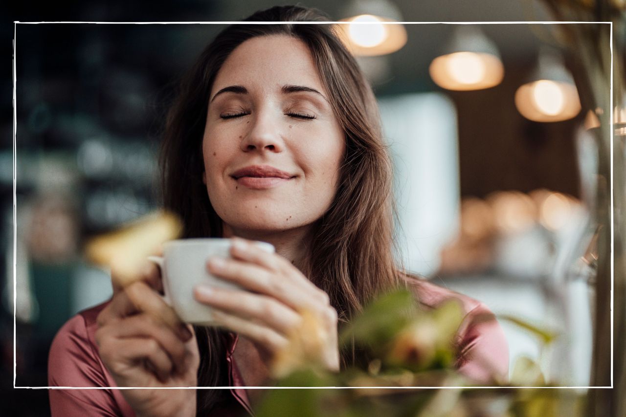 woman savouring coffee in coffee shop