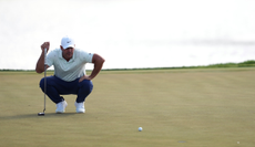 Brooks Koepka lines up a putt