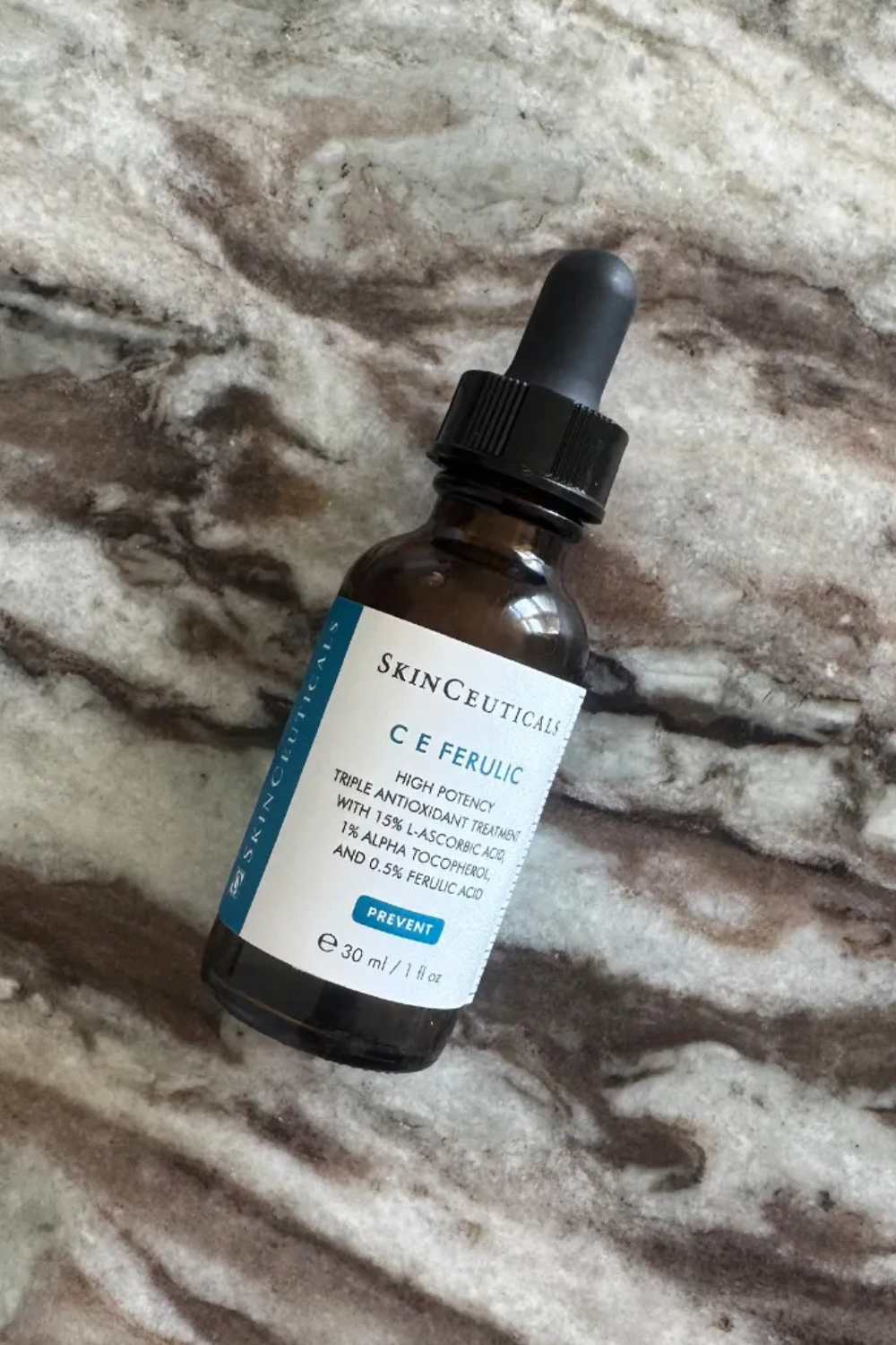 A bottle of Skinceuticals C E ferulic serum on a marble table