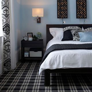 bedroom with geometric carpet and bed