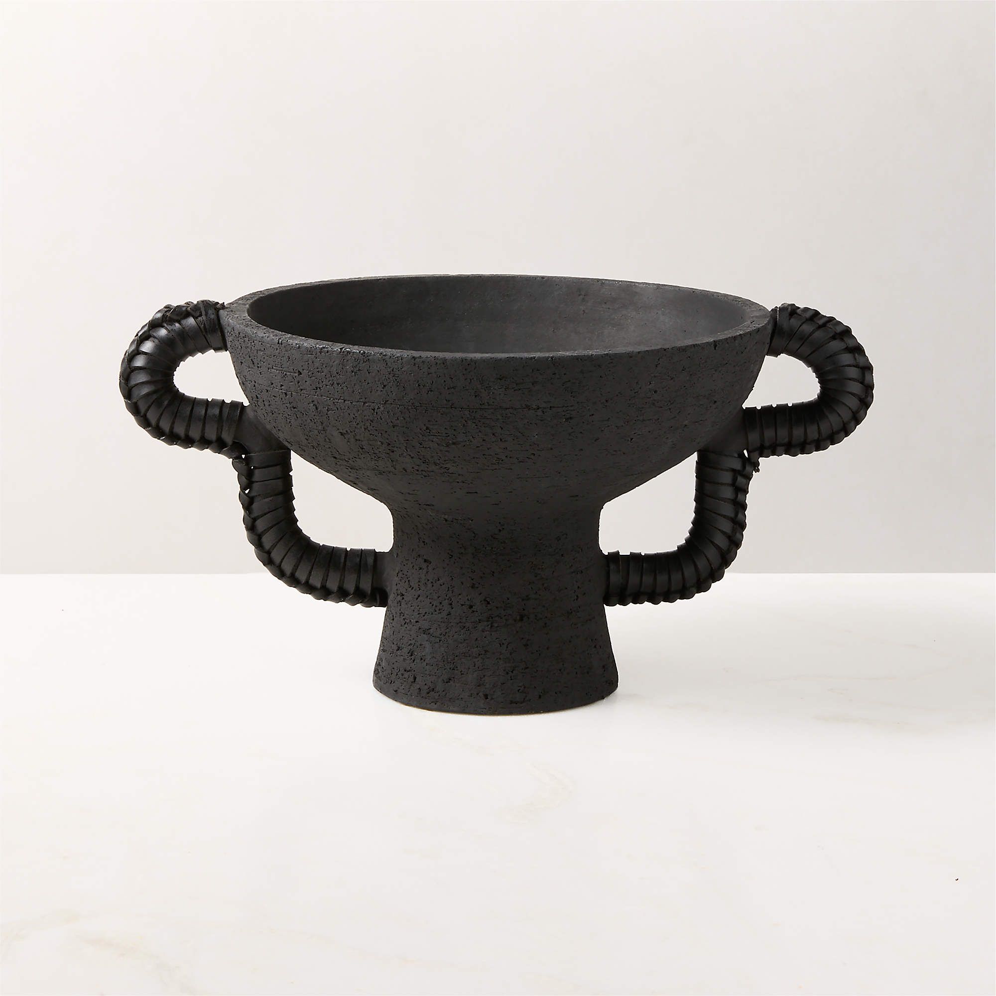 Black pedestal bowl with curved leather handles