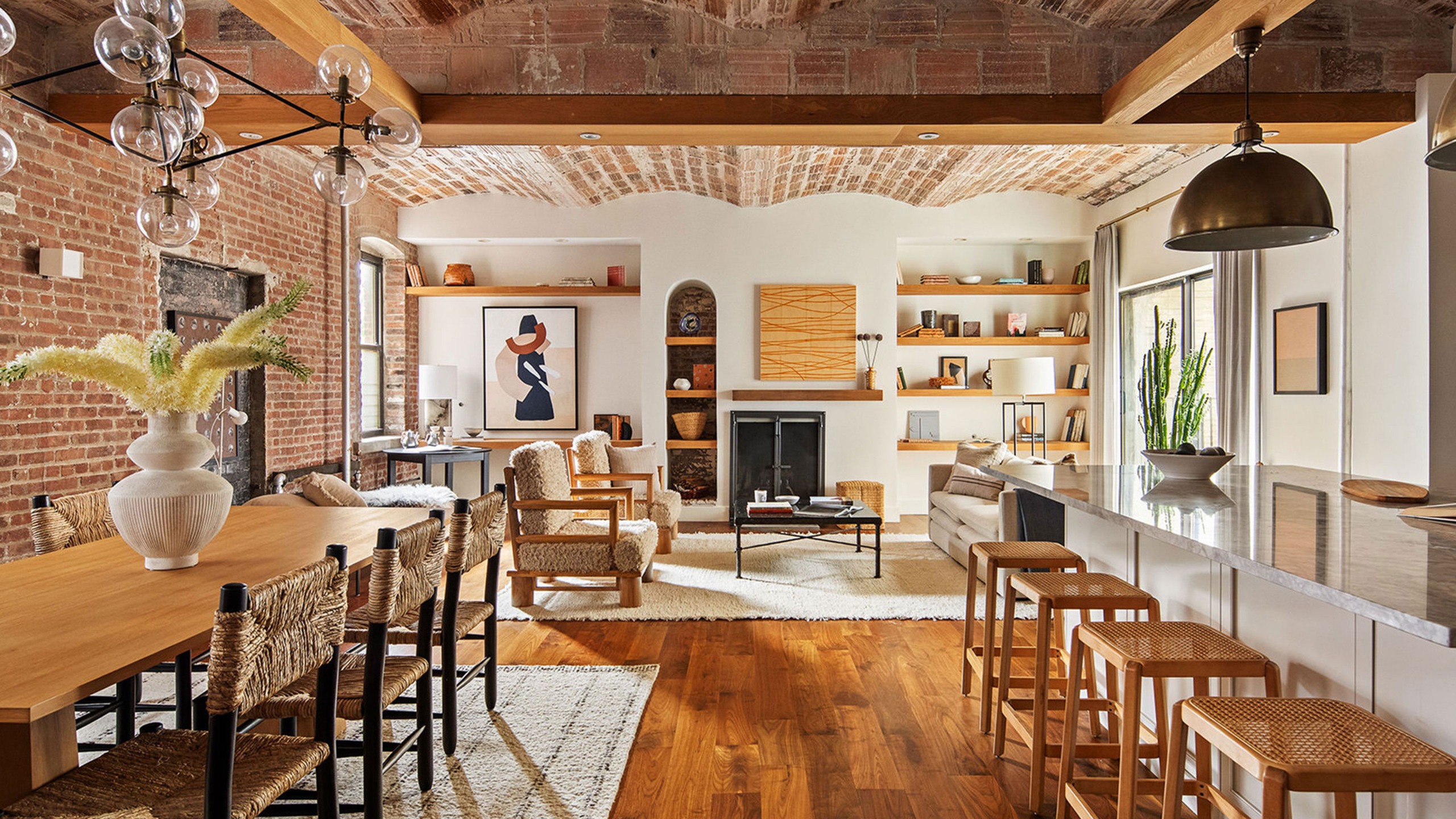 open plan kitchen dining and living space with brick barrel ceiling