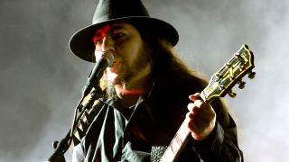Daron Malakian performing onstage with System Of A Down in 2022