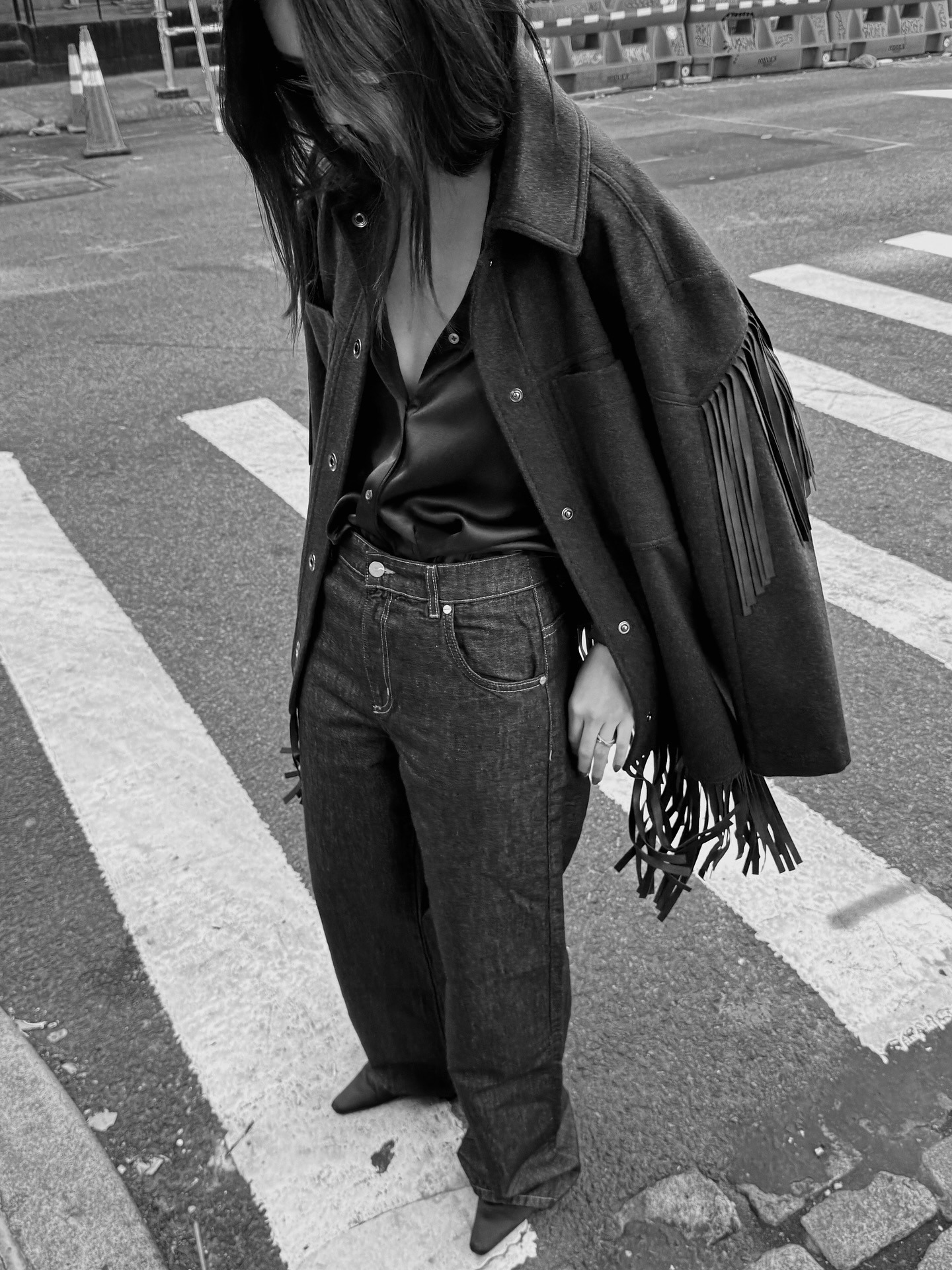 @mimixn wearing a navy blue fringe jacket with jeans.